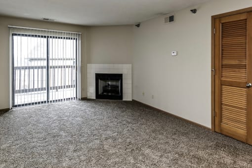 Large living room with wood-burning fireplace at Southwest Gables Apartments, Omaha NE