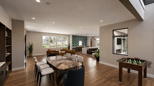 A modern dining room with a large table and chairs.