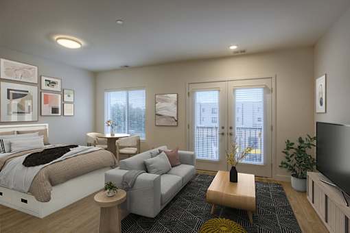 A modern bedroom with a large bed and a grey couch.