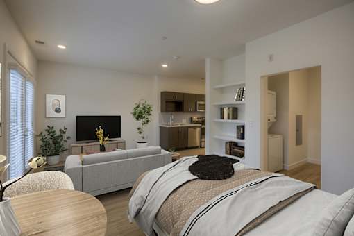 A modern bedroom with a large bed and a living area with a couch and television.