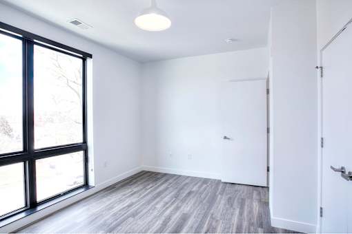 A room with a sliding glass door and a white door.