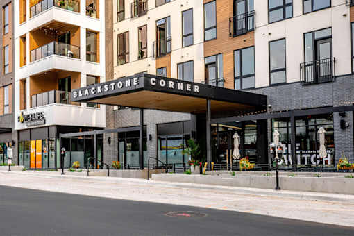 A street view of a building with the sign Blackstone Corner.