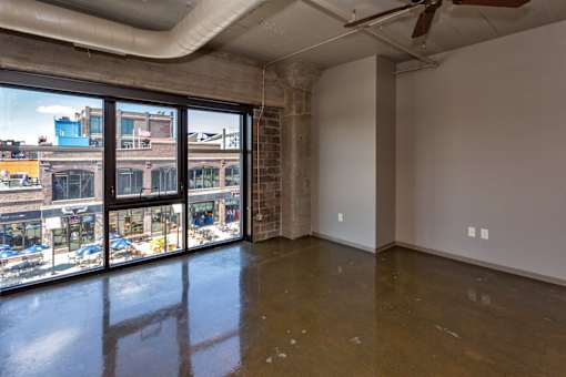 A room with a large window overlooking a city street.