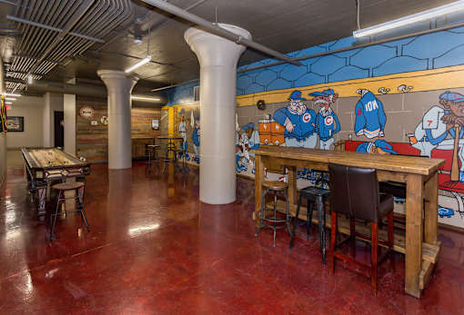 A room with a mural of baseball players on the wall.