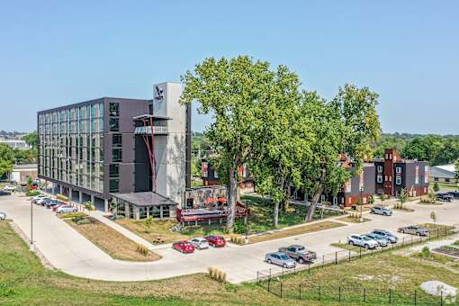 A modern building with a parking lot in front.