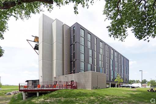 A modern building with a combination of grey and black panels.