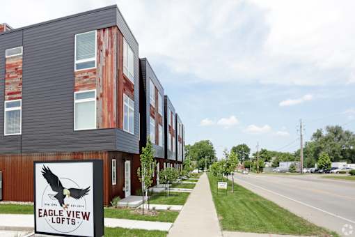 A sign for Eagle View Lofts stands in front of a building.