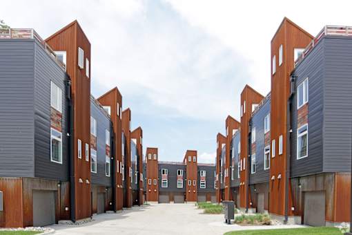 A series of modern buildings with red and grey exteriors.