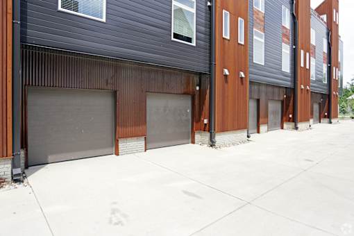 A long building with a lot of windows and garage doors.