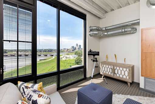 A room with a large window overlooking a cityscape.