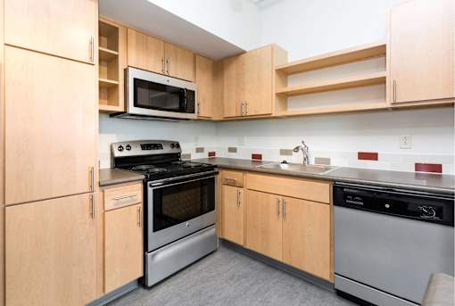 A kitchen with wooden cabinets and stainless steel appliances.