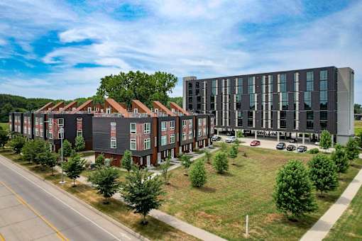 A large building with a parking lot in front of it.