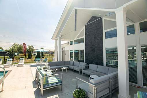 A patio with a pool table and chairs.