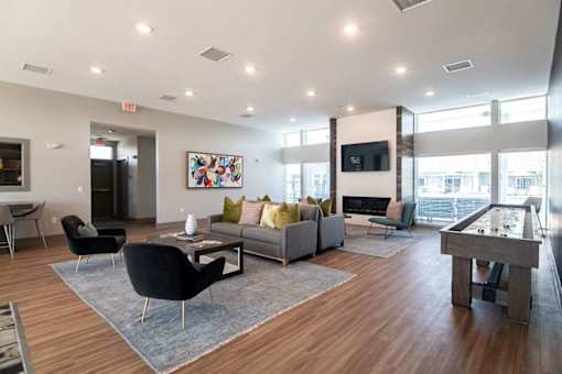 A modern living room with a pool table and a television.