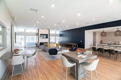 A modern dining room with a table set for six.