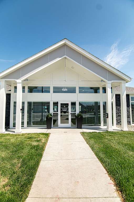 A white building with a glass door and windows.