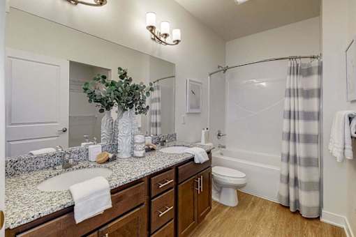 A bathroom with a marble countertop and a white towel.