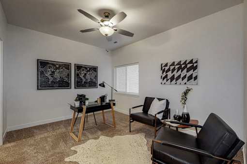 A living room with a black and white checkered picture on the wall.