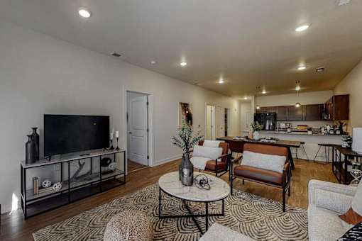 A living room with a black television and a glass cabinet.