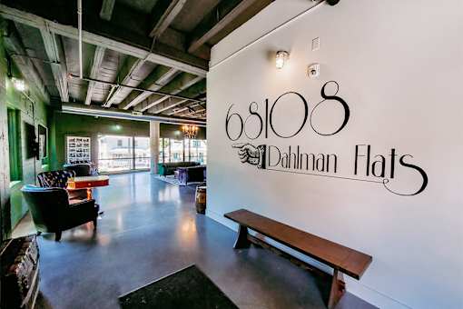 A room with a bench and a wall that says "68108 Dalman Flats".