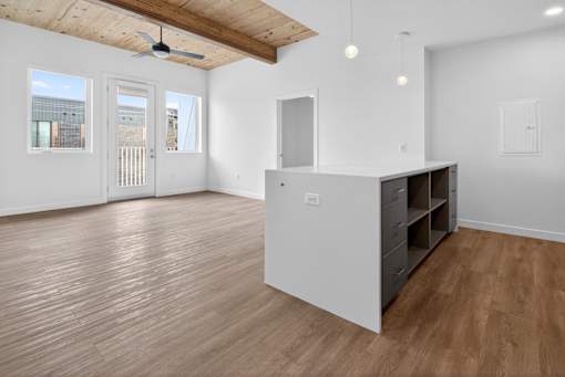 A room with wooden floors and a ceiling fan.