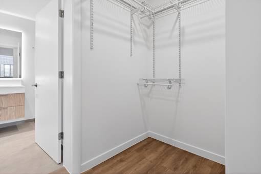 A white bathroom with a hanging shower.