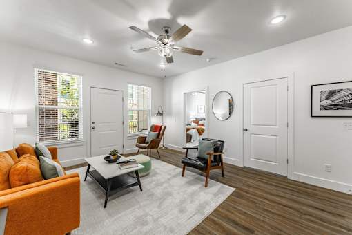 A living room with a ceiling fan and a couch.