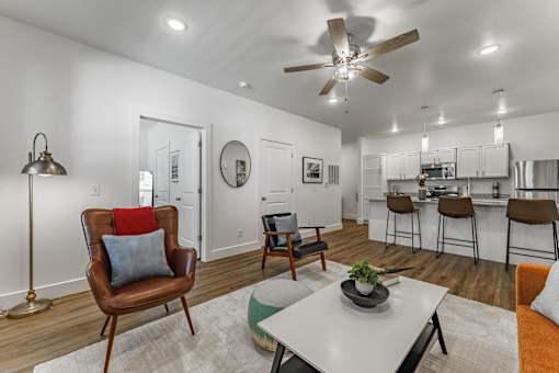 A living room with a brown chair and a white table.
