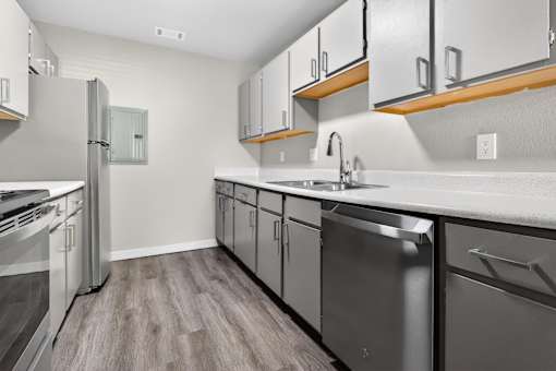 A modern kitchen with stainless steel appliances and wooden accents.