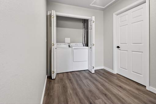 A small laundry room with a washer and dryer.