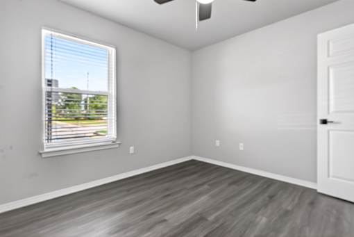 A room with a window and a door.