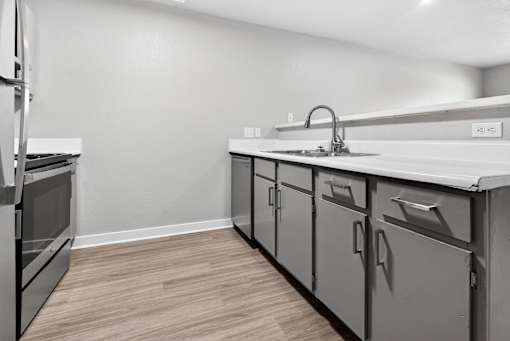 A kitchen with a sink and cabinets.