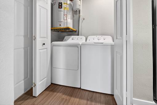 A small laundry room with a washer and dryer.