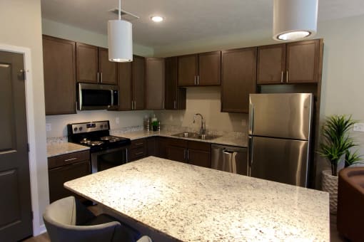 Large kitchens with stainless steel appliances and granite countertops at The Flats at 5th in Columbus, NE