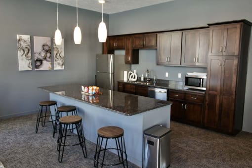 Large kitchens with stainless steel appliances and granite countertops at The Flats at 5th in Columbus, NE