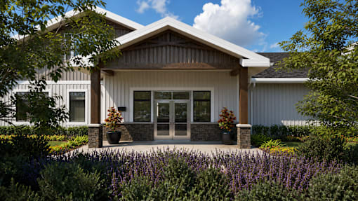 A modern house with a front yard and purple flowers.
