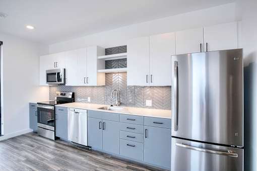 A modern kitchen with a stainless steel refrigerator.