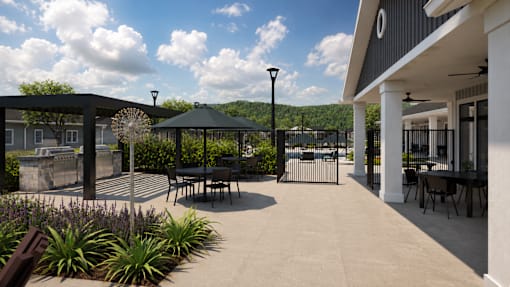 A patio area with a table and chairs under a gazebo.