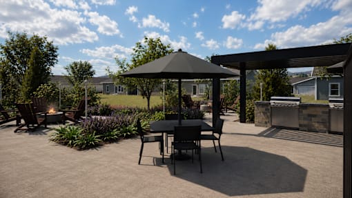 A patio with a table and chairs under a gazebo.