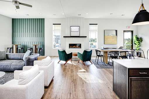 A living room with a fireplace and a dining table.