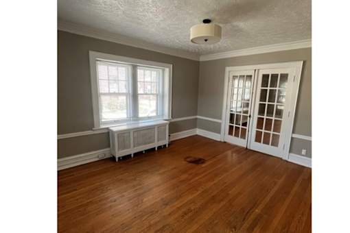 A room with a window and a door.