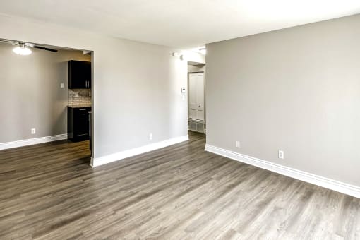 a bedroom with hardwood floors and grey walls