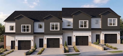 A modern two-story house with a white garage door.