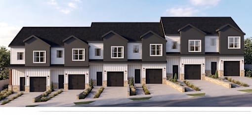 A row of houses with garages in front.