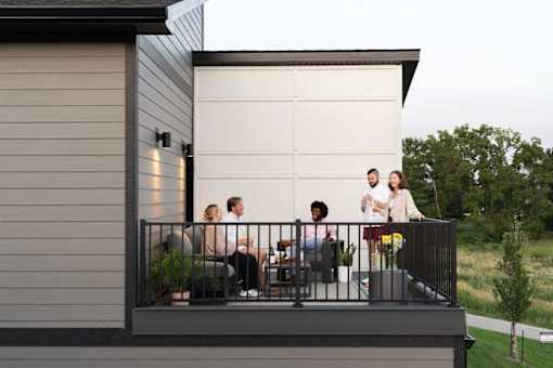 A group of people are sitting on a balcony.