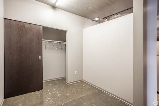 A room with a brown door and a white wall.