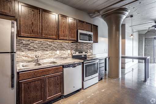 A kitchen with wooden cabinets and stainless steel appliances.