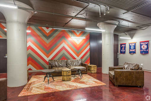 A room with a chevron patterned wall and a couch.