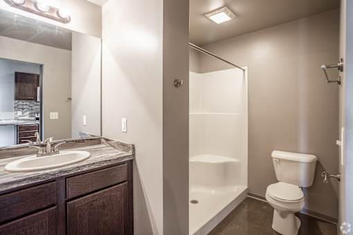 A bathroom with a toilet, sink, and bathtub.