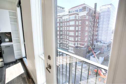 A view of a construction site from a window in a room.